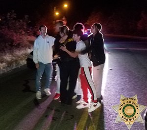 Deputy Elliott embraces with a group of young men shortly after they helped free her from a suspect who put her in a headlock on July 18, 2020 in King County, Washington. (Photo/King County Sheriff's Office)