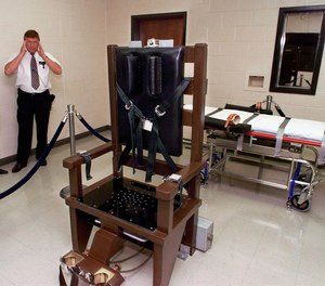 FILE - In this Oct. 13, 1999, file photo, Ricky Bell, the warden at Riverbend Maximum Security Institution in Nashville, Tenn., gives a tour of the prison's execution chamber. If Tennessee electrocutes Zagorski, it will be in an electric chair built by a self-taught execution expert who is no longer welcome in the prison system.