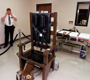 FILE - In this Oct. 13, 1999, file photo, Ricky Bell, the warden at Riverbend Maximum Security Institution in Nashville, Tenn., gives a tour of the prison's execution chamber. If Tennessee electrocutes Zagorski, it will be in an electric chair built by a self-taught execution expert who is no longer welcome in the prison system.