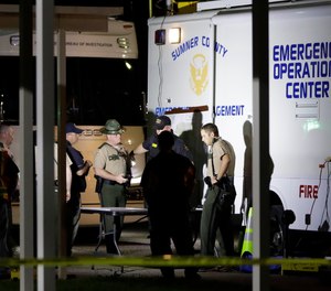 Law enforcement officials work at a command center set up at North Sumner Elementary School Saturday, April 27, 2019, in Bethpage, Tenn.