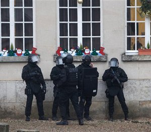 French riot officers patrol in Longpont, north of Paris, France, Thursday, Jan. 8, 2015.