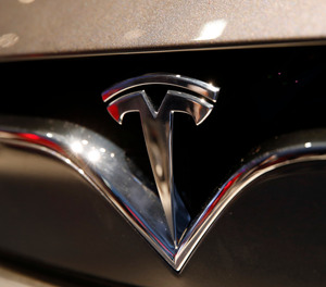 This Oct. 3, 2018, file photo shows a Tesla emblem at the Auto show in Paris.