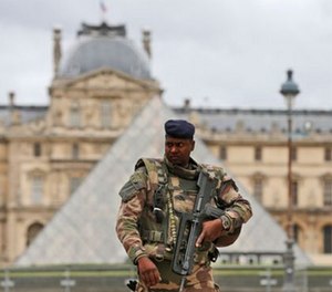 Police officers patrol at the Eiffel Tower in Paris, Tuesday, Nov. 17, 2015.