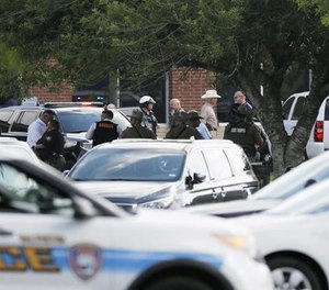 Emergency responders work at the scene in front of Santa Fe High School in response to a shooting on Friday, May 18, 2018, during which officers rapidly responded and contained a school shooter within four minutes.