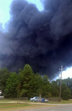 Smoke rises from a series of explosions from the oil field chemical supply firm DrillChem in Conroe, Texas, on Friday, Aug. 14, 2015. The dense column of thick, black smoke was visible for miles. (Brandon K. Scott/Conroe Courier via AP)