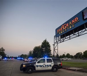A Lafayette Police Department vehicle blocks an entrance at The Grand Theatre in Lafayette, La., following a shooting at the theater, Thursday, July 23, 2015. (Paul Kieu/The Daily Advertiser via AP)