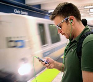 Nick Sabatasso checks his cell phone while waiting for a BART train at San Francisco's Civic Center station.