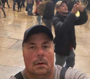 Federal prosecutors say Thomas Fee, 53, a retired FDNY firefighter, sent this selfie to a friend from the rotunda of the Capitol during the storming of the building on Jan. 6. Fee surrendered to authorities Tuesday morning and faces charges of disorderly conduct and entering a restricted building without permission.