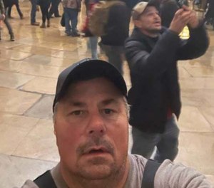 Federal prosecutors say Thomas Fee, 53, a retired FDNY firefighter, sent this selfie to a friend from the rotunda of the Capitol during the storming of the building on Jan. 6. Fee surrendered to authorities Tuesday morning and faces charges of disorderly conduct and entering a restricted building without permission.