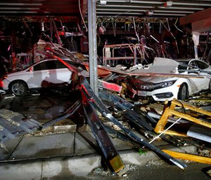 Cars and trucks are damaged as the walls blew out of the I-20 Dodge dealership after a tornado hit near Canton, Texas, Saturday, April 29, 2017. (Tom Fox/The Dallas Morning News via AP)