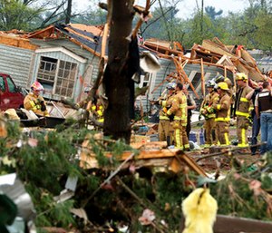 Firefighters work the site of the damage after a tornado ripped through Prairie Lake Estates trailer home park, just north of Chetek, Wis. (Dan Reiland/The Eau Claire Leader-Telegram via AP)