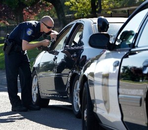 In this Nov. 12, 2012 file photo, a police officer makes a traffic stop in Sacramento, Calif.
