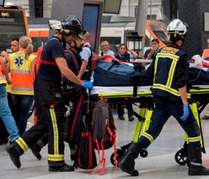 An injured passenger is taken away on a stretcher from a train station in Barcelona, Spain.
