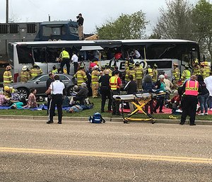 Emergency personnel assist injured passengers after their charter bus collided with a train in Biloxi, Miss., Tuesday, March 7, 2017.