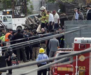 Sen. Pat Toomey, center white shirt, Philadelphia Mayor Michael Nutter, center tan shirt, and Sen. Robert Casey, right blue shirt, tour the scene of a deadly train wreck, Wednesday, May 13, 2015, in Philadelphia. An Amtrak train headed to New York City derailed and crashed in Philadelphia on Tuesday night killing at least seven people and injuring dozens more.