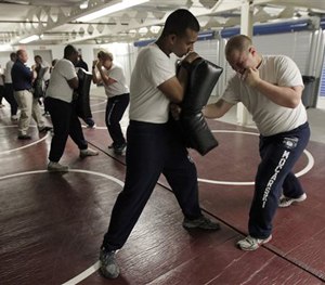 In this Wednesday, June 17, 2015, photo Steven Mocarski, right, punches a pad held by Ryan Ali during a Jersey City Police Department training exercise in Jersey City, N.J.