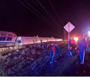 Passengers gather after a train derailed near Dodge City, Kan., Monday, March 14, 2016.