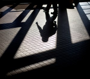 In this Friday, Dec. 7, 2012 photo, the shadow of a Georgia Department of Juvenile Justice correctional officer is cast as he leaves a training facility in Forsyth, Ga.