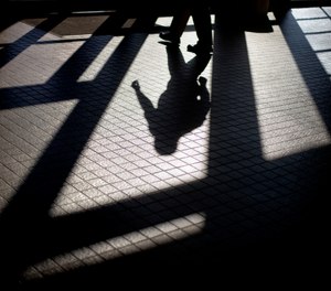 In this Friday, Dec. 7, 2012 photo, the shadow of a Georgia Department of Juvenile Justice correctional officer is cast as he leaves a training facility in Forsyth, Ga.