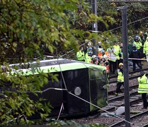 Emergency service workers attend the scene of a derailed tram in Croydon, south London. (Steve Parsons/PA via AP)