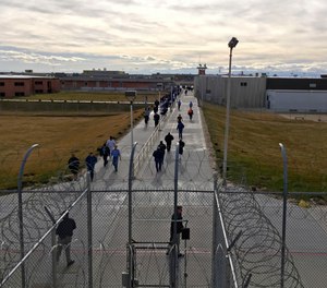 In this Jan. 30, 2018 file photo, inmates walk across the grounds of the Idaho State Correctional Institution in Kuna, Idaho. (AP Photo/Rebecca Boone, File)