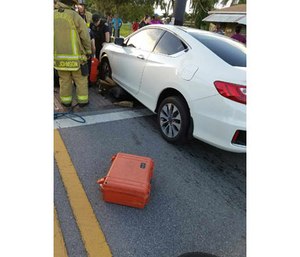 Crews work to extricate the trapped man.