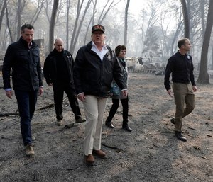 A somber President Trump toured the devastation of California’s deadly wildfires Saturday. (Photo/AP)