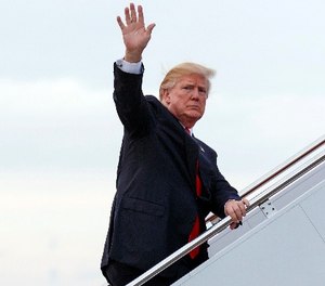 In this Monday, Jan. 1, 2018 file photo, President Donald Trump boards Air Force One at Palm Beach International Airport, in West Palm Beach, Fla.