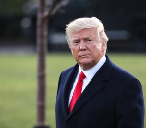 President Donald Trump walks on the South Lawn to board Marine One at the White House in Washington on Dec. 18, 2019.