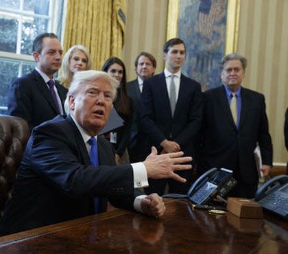 President Donald Trump talks with reporters n the Oval Office of the White House in Washington, Tuesday, Jan. 24, 2017, before signing an executive order on the Keystone XL pipeline.