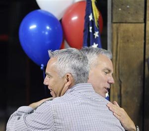 In this photo taken on May 31, 2013, Rob Snaza, right, hugs his brother and Thurston County sheriff John Snaza, left, during a meet and greet event at the Napavine Feed Store in Napavine, Wash.