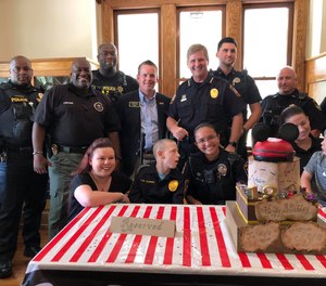 Crystal and Tye Clinner and Lt. Brandy Forman pose with the cake Forman baked for Tye Clinner's birthday.