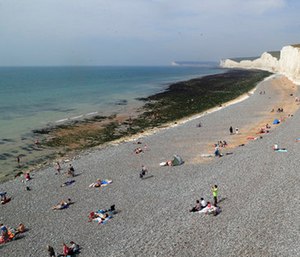 People relax on the beach at Birling Gap in Eastboune, Sussex, England.
