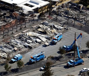 Pacific Gas & Electric crews work on restoring power lines in a fire ravaged neighborhood in an aerial view in the aftermath of a wildfire in Santa Rosa, Calif. (AP Photo/Marcio Jose Sanchez)
