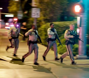 In this Oct. 1, 2017, file photo, police run toward the scene of a shooting near the Mandalay Bay resort and casino on the Las Vegas Strip in Las Vegas. In documents made public Thursday, Dec. 27, 2018, police in Las Vegas have released transcripts of some officers' accounts about what they saw, heard and did trying to locate and stop a gunman who unleashed the deadliest mass shooting in the nation's modern history almost 15 months earlier. (AP Photo/John Locher, File)
