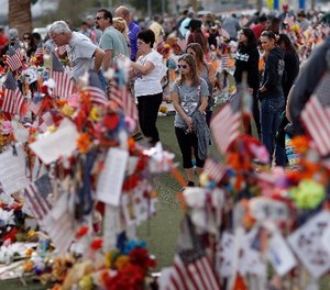 People visit a makeshift memorial honoring the victims of the Oct. 1 mass shooting, Sunday, Nov. 12, 2017, in Las Vegas.