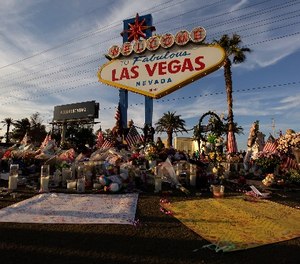 People visit a makeshift memorial for victims of the mass shooting in Las Vegas, Monday, Oct. 16, 2017, in Las Vegas.