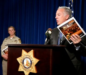 Clark County Sheriff Joe Lombardo announces the release of the Oct. 1, 2017, shooting After-Action Review with report authors Detective Stephanie Ward, left, and Capt. Kelly McMahill during a news conference at Metropolitan Police Department headquarters Las Vegas Wednesday, July 10, 2019.