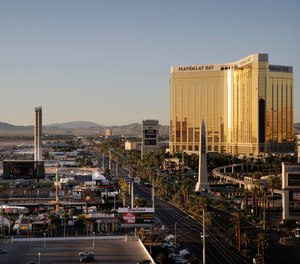 This Oct. 3, 2017, file photo shows the Mandalay Bay resort and casino, right, overlooking an outdoor festival grounds across the street, left, in Las Vegas.