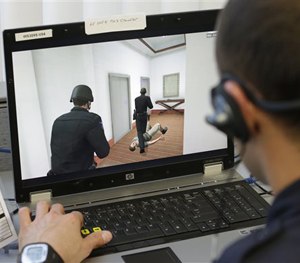 Sacramento Police Officer Vance Chandler moves his virtual character through a hallway while using a new computerized training system in Sacramento, Calif., Wednesday, Nov. 20, 2013.