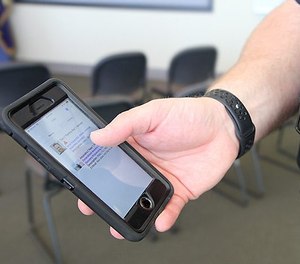 A Fort Collins Police Officer, who serves on the mental health co-responder team, demonstrates how the Vitals app works on his phone. The profile he’s showing is a “test” profile set up for the purpose of officer training.