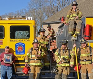 The Kuchyt family. From left: Martin (holding a picture of his late brother Robert), Jamie, Teresa, young Martin, Scott, Mike (up top) and Kyle.