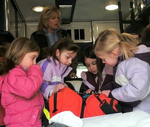 In this photo, kids explore an ambulance during a show and tell. Taking the ambulance out to interact with the public is great practice which builds confidence in low-volume providers and develops a rapport with the community. (Image Nancy Magee)
