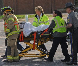 Police, volunteer and paid EMS, and volunteer fire work together at a SADD drill.