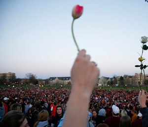 People gather for a vigil on the drill field following the shootings on the Virginia Tech campus in Blacksburg, Va. (AP Photo/Casey Templeton, File)