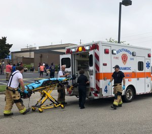 Medical staff stage outside a Walmart store, Tuesday, July 30, 2019, in Southaven, Miss. (AP Photo/Adrian Sainz)