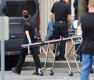 A worker carries a stretcher at the Cascade Mall Saturday, Sept. 24, 2016, in Burlington, Wash.