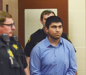 Arcan Cetin is escorted into Skagit County District Court by Skagit County's Sheriff's Deputies on Monday, Sept. 26, 2016.
