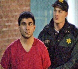 This late Saturday, Sept. 24, 2016, image from video by KIRO7 photographer Jeff Ritter shows suspected Cascade Mall shooter Arcan Cetin at Skagit County Jail in Mount Vernon, Wash., after his arrest in Oak Harbor, Wash., earlier in the evening.