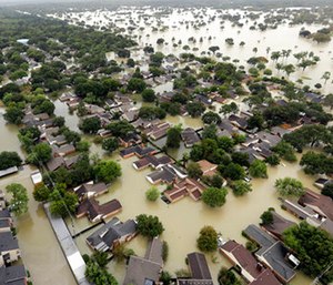 Water from Addicks Reservoir flows into neighborhoods as floodwaters from Tropical Storm Harvey rise in Houston.
